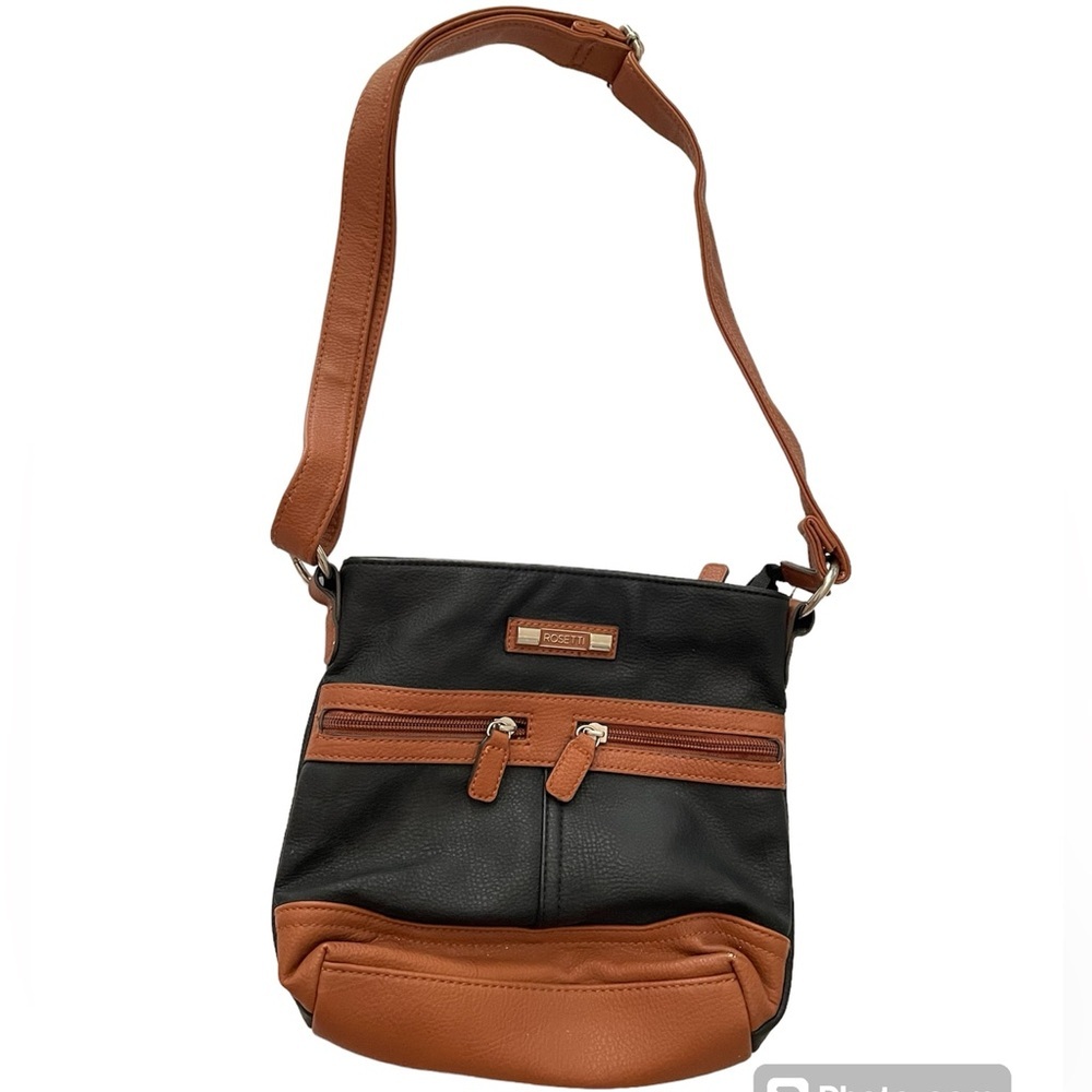 Black ROSETTI shoulder bag w/tan trim. Adjustable shoulder strap.Zipper closure